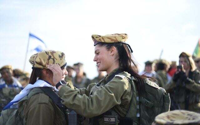 File: An officer in the Border Defense Corps places a beret on a soldier's head, in an undated photo published by the military. (Israel Defense Forces) File: An officer in the Border Defense Corps places a beret on a soldier's head, in an undated photo published by the military. (Israel Defense Forces)