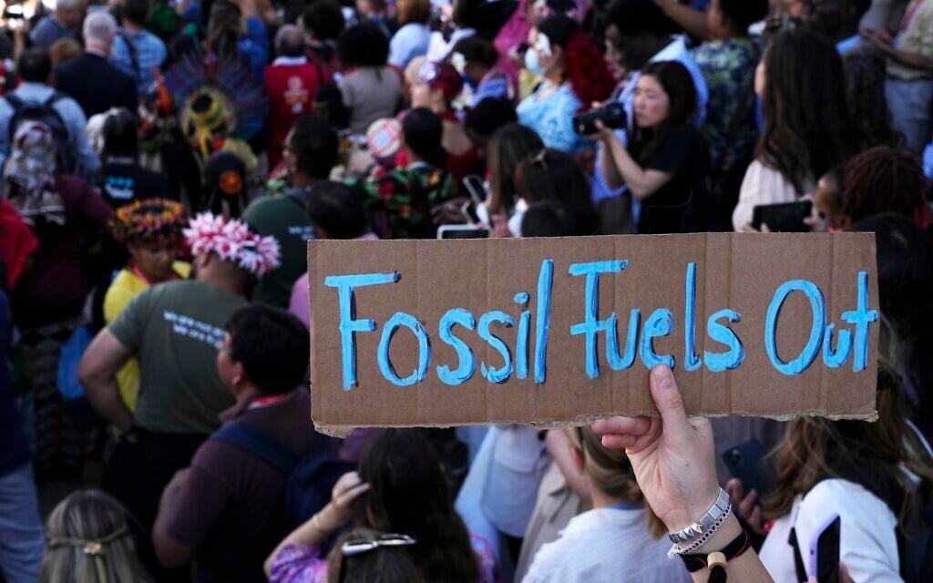 FILE - A sign reading "fossil fuels out" is displayed during a demonstration at the COP27 UN Climate Summit, on November 12, 2022, in Sharm el-Sheikh, Egypt. (AP Photo/Peter Dejong, File) FILE - A sign reading "fossil fuels out" is displayed during a demonstration at the COP27 UN Climate Summit, on November 12, 2022, in Sharm el-Sheikh, Egypt. (AP Photo/Peter Dejong, File)