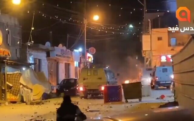 A screenshot from a video showing Palestinians hurling stones at Israeli military vehicles in Beit Ummar, near the West Bank city of Hebron. (WANBreaking on Twitter, used in accordance with Clause 27a of the Copyright Law) A screenshot from a video showing Palestinians hurling stones at Israeli military vehicles in Beit Ummar, near the West Bank city of Hebron. (WANBreaking on Twitter, used in accordance with Clause 27a of the Copyright Law)