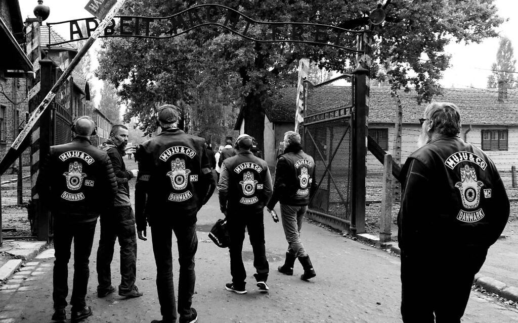 Members of the MuJu & Co. pass under the infamous 'Work Will Make You Free' sign at the Auschwitz-Birkenau Memorial Museum in Poland on October 1, 2022. (Courtesy of Dan Meyrowitsch)