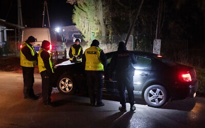 Police officers gather outside a grain depot where the Polish Foreign Ministry said a Russian-made missile fell and killed two people in Przewodow, eastern Poland, on November 15, 2022. (AP Photo) Police officers gather outside a grain depot where the Polish Foreign Ministry said a Russian-made missile fell and killed two people in Przewodow, eastern Poland, on November 15, 2022. (AP Photo)