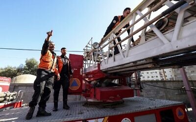 Palestinian firefighters check their equipment at the headquarters of the civil defense unit in Gaza City, on November 23, 2022. (MAHMUD HAMS/AFP)