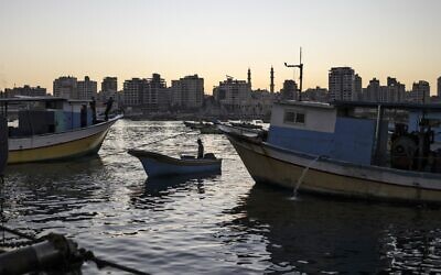 A Palestinian fisherman arrives with a boat at the port Gaza City early on December 1, 2022. (Ronaldo Schemidt/AFP)