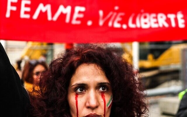 A protestor with red tears painted on her face during a rally in support of the demonstrations in Iran, in Toulouse, south-western France, on December 3, 2022. (Charly TRIBALLEAU / AFP) A protestor with red tears painted on her face during a rally in support of the demonstrations in Iran, in Toulouse, south-western France, on December 3, 2022. (Charly TRIBALLEAU / AFP)