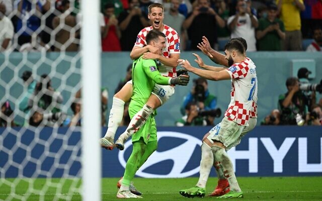 Croatia's goalkeeper Dominik Livakovic celebrates with teammates after their victory in the Qatar 2022 World Cup round of 16 football match between Japan and Croatia at the Al-Janoub Stadium in Al-Wakrah, south of Doha on December 5, 2022. (Ina Fassbender / AFP) Croatia's goalkeeper Dominik Livakovic celebrates with teammates after their victory in the Qatar 2022 World Cup round of 16 football match between Japan and Croatia at the Al-Janoub Stadium in Al-Wakrah, south of Doha on December 5, 2022. (Ina Fassbender / AFP)