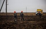 Workers repair high-voltage power lines cut by recent missile strikes near Odessa on December 7, 2022, amid the Russian invasion of Ukraine. (OLEKSANDR GIMANOV / AFP, file)