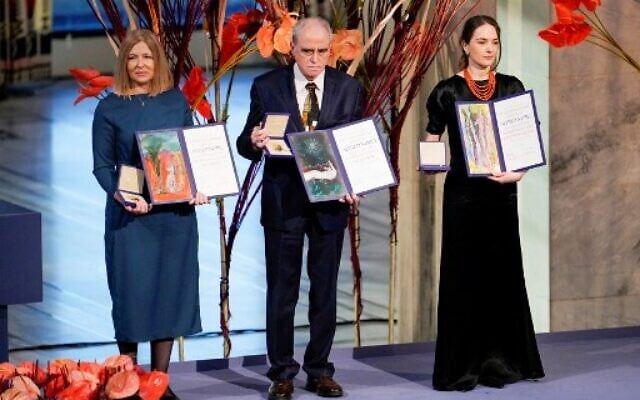Natalia Pinchuk (L) on behalf of her husband Nobel Peace Prize 2022 winner, jailed Belarusian activist Ales Bialiatski, Memorial chairman Yan Rachinsky (C) on behalf of Russian human rights organisation Memorial, and Head of the Ukrainian Center for Civil Liberties (CCL) Oleksandra Matviichuk pose with their Nobel Peace Prize certificates and medals during the 2022 Nobel Peace Prize award ceremony at the City Hall in Oslo, Norway, on December 10, 2022. (Rodrigo Freitas/NTB/AFP) Natalia Pinchuk (L) on behalf of her husband Nobel Peace Prize 2022 winner, jailed Belarusian activist Ales Bialiatski, Memorial chairman Yan Rachinsky (C) on behalf of Russian human rights organisation Memorial, and Head of the Ukrainian Center for Civil Liberties (CCL) Oleksandra Matviichuk pose with their Nobel Peace Prize certificates and medals during the 2022 Nobel Peace Prize award ceremony at the City Hall in Oslo, Norway, on December 10, 2022. (Rodrigo Freitas/NTB/AFP)