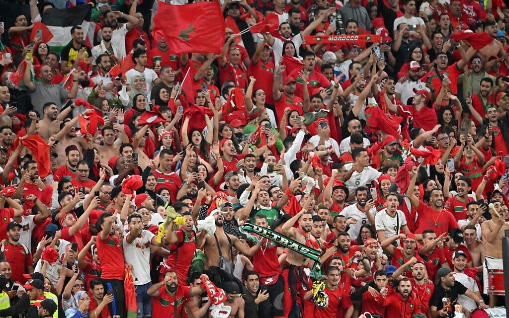 Morocco fans celebrate their team winning the Qatar 2022 World Cup quarter-final soccer match against Portugal at the Al-Thumama Stadium in Doha on December 10, 2022. (Photo by Alberto PIZZOLI / AFP)