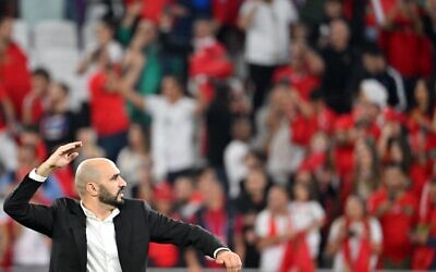 Morocco's coach Walid Regragui celebrates winning the Qatar 2022 World Cup quarterfinal soccer match between Morocco and Portugal at the Al-Thumama Stadium in Doha on December 10, 2022. (Photo by Alberto PIZZOLI / AFP)