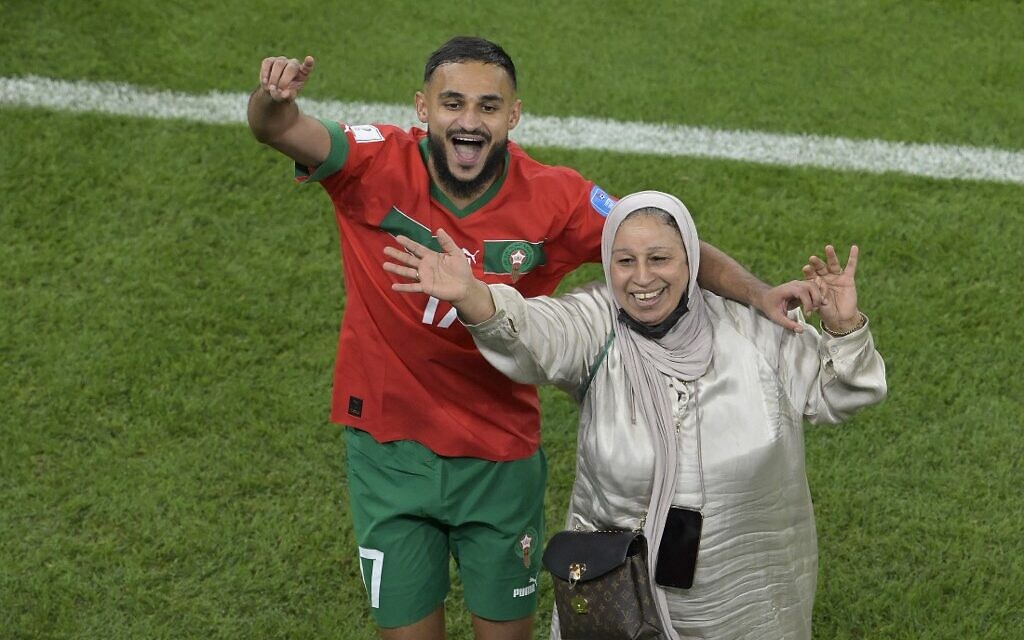 Morocco's midfielder Sofiane Boufal celebrates with his mother after Morocco defeated Portugal 1-0 in the Qatar 2022 World Cup quarter-final soccer match at the Al-Thumama Stadium in Doha on December 10, 2022. (JUAN MABROMATA / AFP)