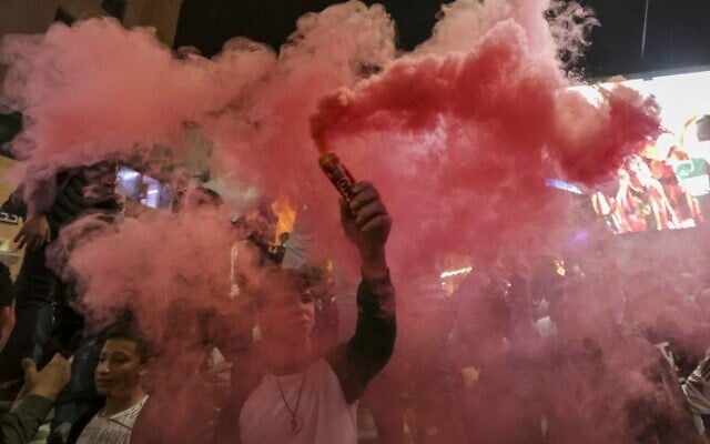 Palestinians celebrate Morocco's win over Portugal in the streets of the West Bank city of Hebron after the Qatar 2022 World Cup quarter-final soccer match between Morocco and Portugal on December 10, 2022. (HAZEM BADER / AFP)