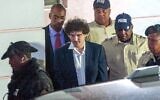 FTX founder Sam Bankman-Fried (C) is led away handcuffed by officers of the Royal Bahamas Police Force in Nassau, Bahamas on December 13, 2022. (Mario Duncanson / AFP)