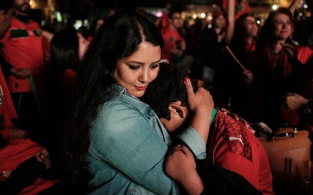 A Moroccan supporter comforts her son after the Qatar 2022 World Cup soccer semifinal match between Morocco and France, in Nairobi, on December 14, 2022. (Yasuyoshi Chiba/AFP) A Moroccan supporter comforts her son after the Qatar 2022 World Cup soccer semifinal match between Morocco and France, in Nairobi, on December 14, 2022. (Yasuyoshi Chiba/AFP)