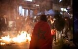 Moroccan supporters light a fire in a street in Brussels after Morocco's football team lost the Qatar 2022 World Cup semi-final football match against France, December 14, 2022. (Simon Wohlfahrt / AFP)