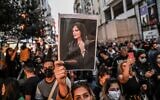 A protester holds a portrait of Mahsa Amini during a demonstration in support of Amini, a young Iranian woman who died after being arrested in Tehran by the Islamic Republic's morality police, on Istiklal avenue in Istanbul on September 20, 2022. (Ozan Kose/AFP)