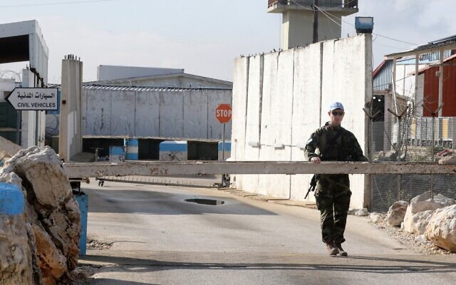 An Irish soldier from the United Nations Interim Force in Lebanon (UNIFIL), stands guard at the entrance of his base in the southern Lebanese village of al-Tiri on December 16 2022, two days after a fellow Irish soldier was killed in the region. (Mahmoud ZAYYAT / AFP)
