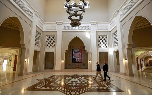 Men walk near a framed picture depicting Jordan's reigning King Abdullah II as they cross the main hall at the King Hussein Bin Talal Convention Centre near the town of Sweimeh in central-west Jordan on December 18, 2022 two days ahead of the "Baghdad Conference for Cooperation and Partnership." (Khalil MAZRAAWI / AFP) Men walk near a framed picture depicting Jordan's reigning King Abdullah II as they cross the main hall at the King Hussein Bin Talal Convention Centre near the town of Sweimeh in central-west Jordan on December 18, 2022 two days ahead of the "Baghdad Conference for Cooperation and Partnership." (Khalil MAZRAAWI / AFP)