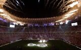 Fireworks at Qatar's Lusail Stadium, as Argentina's players (center) attend the 2022 World Cup trophy ceremony after their victory over France in the final match in Lusail, north of Doha on December 18, 2022. (Odd Andersen/AFP)