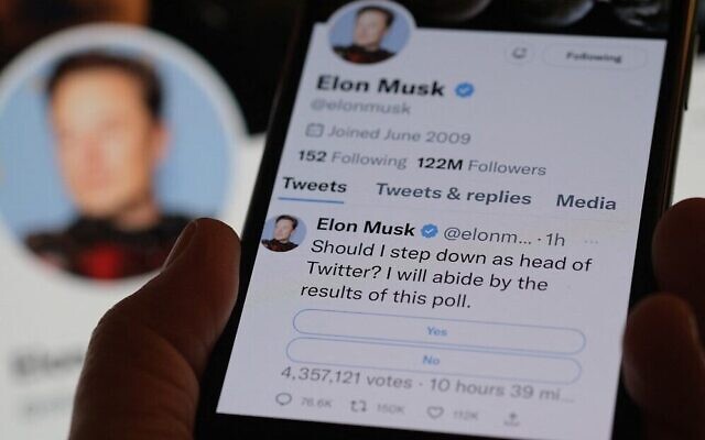 A phone displaying Elon Musk's Twitter page, where the billionaire conducted a platform-based survey about his future as the head of the company, December 18, 2022. (Chris DELMAS/AFP) A phone displaying Elon Musk's Twitter page, where the billionaire conducted a platform-based survey about his future as the head of the company, December 18, 2022. (Chris DELMAS/AFP)
