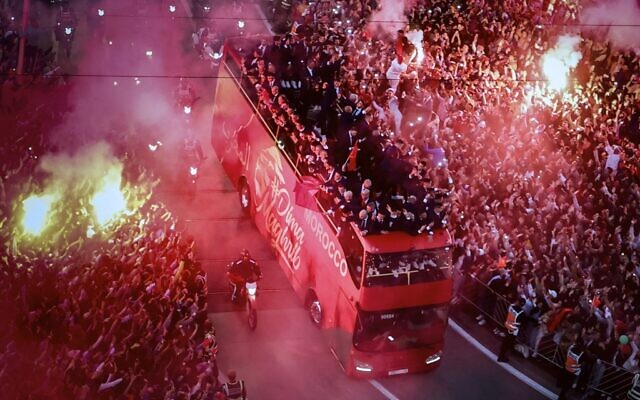 Supporters cheer and light flares as Morocco's national football team arrives to the center of the capital Rabat, on December 20, 2022, after the Qatar 2022 World Cup. (Fadel Senna/AFP) Supporters cheer and light flares as Morocco's national football team arrives to the center of the capital Rabat, on December 20, 2022, after the Qatar 2022 World Cup. (Fadel Senna/AFP)
