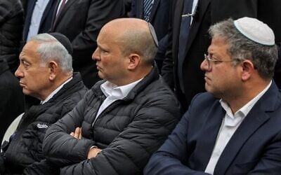 Incoming prime minister Benjamin Netanyahu, left, former prime minister Naftali Bennett, center, and the leader of the Otzma Yehudit party, Itamar Ben Gvir, attend the funeral of Rabbi Chaim Druckman on December 26, 2022. (Gil COHEN-MAGEN / AFP)