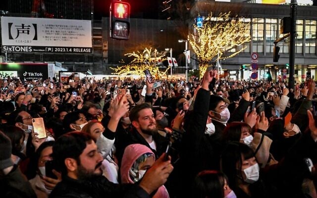 People celebrate the start of New Years Day at midnight in the Shibuya area of Tokyo, Japan, early January 1, 2023. (Richard A. Brooks/AFP) People celebrate the start of New Years Day at midnight in the Shibuya area of Tokyo, Japan, early January 1, 2023. (Richard A. Brooks/AFP)