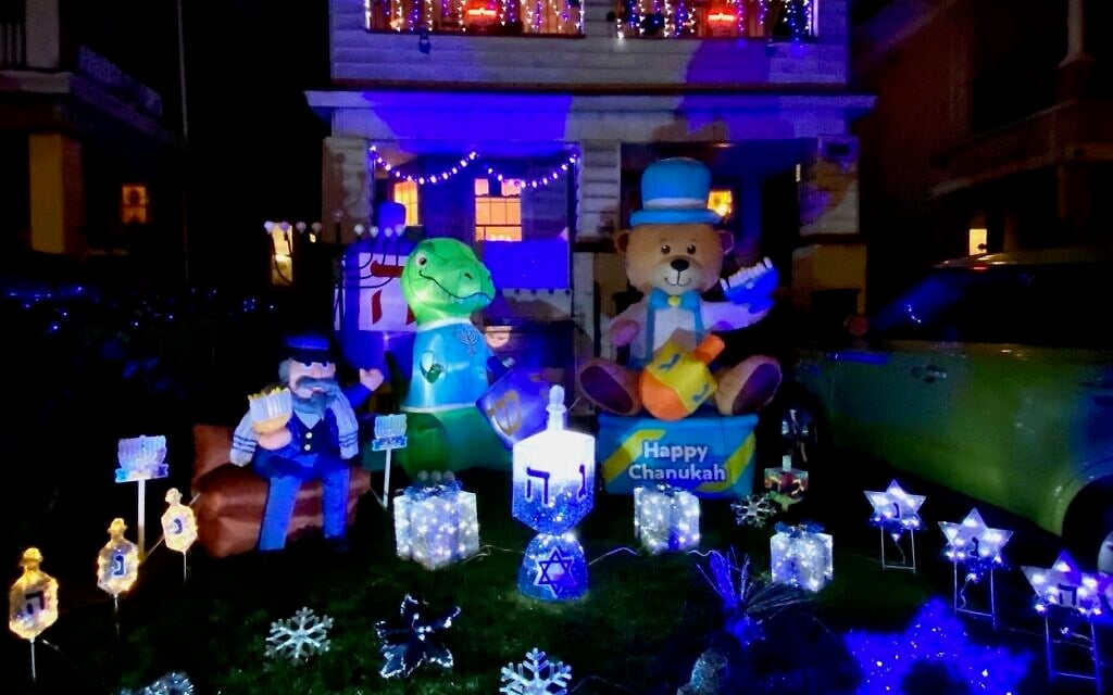 Gail Nalven Fuchs's Hanukkah House in the Midwood neighborhood of Brooklyn is decorated a week before the holiday and stays up a week after with lights, inflatables and other decor. (Courtesy via JTA) Gail Nalven Fuchs's Hanukkah House in the Midwood neighborhood of Brooklyn is decorated a week before the holiday and stays up a week after with lights, inflatables and other decor. (Courtesy via JTA)