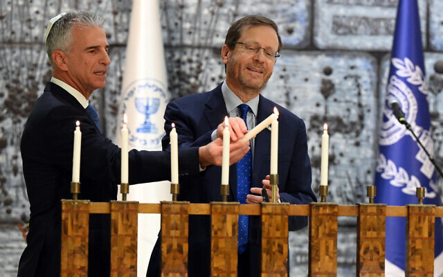 President Isaac Herzog (right) and Mossad head David Barnea light the Hanukkiah at the President's House, December 22, 2022. (Haim Tzach/GPO) President Isaac Herzog (right) and Mossad head David Barnea light the Hanukkiah at the President's House, December 22, 2022. (Haim Tzach/GPO)