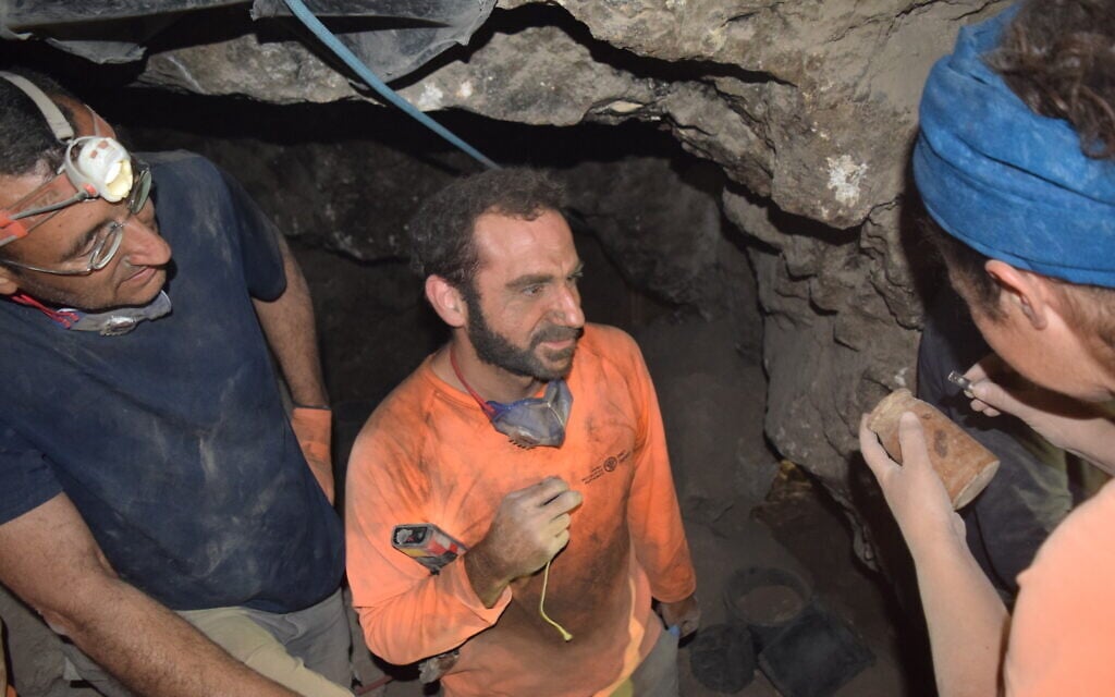 The group examining the 2,200-year-old wooden box discovered in Wadi Muraba‘at near the Dead Sea for the first time, from right to left: Dr. Amir Ganor, Hagay Hamer and Oriah Amichai. (Eitan Klein, Israel Antiquities Authority)