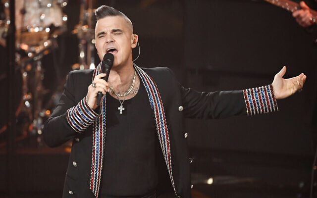Singer Robbie Williams performs during a charity gala in Berlin, Germany, December 7, 2019. (Jens Meyer/AP) Singer Robbie Williams performs during a charity gala in Berlin, Germany, December 7, 2019. (Jens Meyer/AP)
