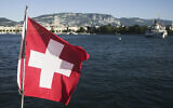 The Switzerland national flag waves in the wind on Lake Geneva in Geneva, Switzerland Sunday, June 13, 2021. (Markus Schreiber/AP)