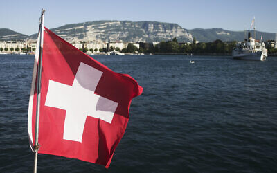 The Switzerland national flag waves in the wind on Lake Geneva in Geneva, Switzerland Sunday, June 13, 2021. (Markus Schreiber/AP)