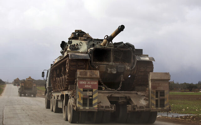 Turkish military convoy drives through the village of Binnish, in Idlib province, Syria, February 8, 2020. (AP Photo/Ghaith Alsayed, File)