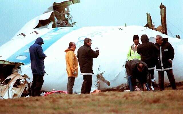 Unidentified crash investigators inspect the nose section of the crashed Pan Am flight 103, a Boeing 747 airliner in a field near Lockerbie, Scotland, December 23, 1988. (Dave Caulkin/AP) Unidentified crash investigators inspect the nose section of the crashed Pan Am flight 103, a Boeing 747 airliner in a field near Lockerbie, Scotland, December 23, 1988. (Dave Caulkin/AP)