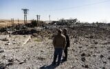 File: People look at a site damaged by Turkish airstrikes that hit an electricity station in the village of Taql Baql, in Hasakeh province, Syria, Sunday, Nov. 20, 2022 (AP Photo/Baderkhan Ahmad, File)