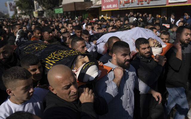 Palestinian mourners carry the bodies of Naeem Jamal Zubaidi, 27, left and Mohammad Ayman Saadi, 26, covered with flags of the Islamic Jihad Movement, during their funeral in the West Bank city of Jenin, Thursday, Dec. 1, 2022. (AP Photo/Nasser Nasser) Palestinian mourners carry the bodies of Naeem Jamal Zubaidi, 27, left and Mohammad Ayman Saadi, 26, covered with flags of the Islamic Jihad Movement, during their funeral in the West Bank city of Jenin, Thursday, Dec. 1, 2022. (AP Photo/Nasser Nasser)