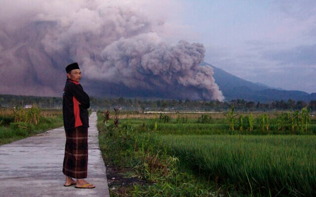 A man looks on as Mount Semeru releases volcanic materials during an eruption on December 4, 2022 in Lumajang, East java, Indonesia (AP Photo) A man looks on as Mount Semeru releases volcanic materials during an eruption on December 4, 2022 in Lumajang, East java, Indonesia (AP Photo)