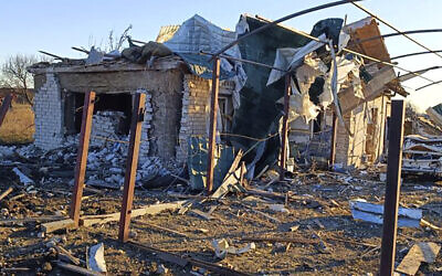 In this photo provided by the Zaporizhzhia region military administration, a damaged building and a car are seen after a Russian strike in the village of Novosofiivka, in the Zaporizhzhia region, Ukraine, December 5, 2022. (Zaporizhzhia region military administration via AP)