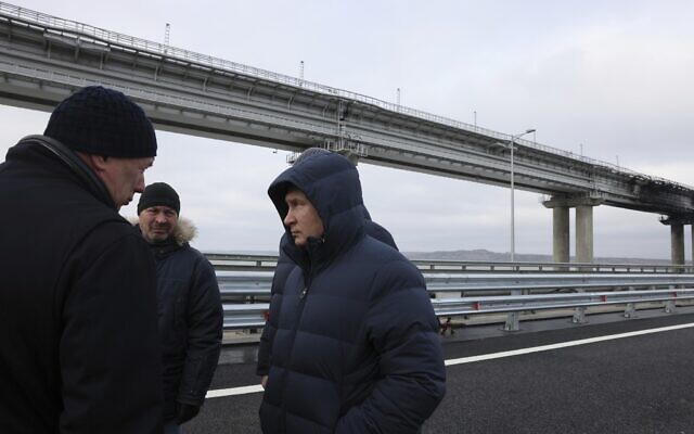 Russian President Vladimir Putin, center, listens to Deputy Prime Minister Marat Khusnullin, left, as he visits the Crimean Bridge connecting Russian mainland and Crimean peninsula over the Kerch Strait, which was damaged by a truck bomb attack in October, after restoration works, not far from Kerch, Crimea, Monday, Dec. 5, 2022. (Mikhail Metzel, Sputnik, Kremlin Pool Photo via AP) Russian President Vladimir Putin, center, listens to Deputy Prime Minister Marat Khusnullin, left, as he visits the Crimean Bridge connecting Russian mainland and Crimean peninsula over the Kerch Strait, which was damaged by a truck bomb attack in October, after restoration works, not far from Kerch, Crimea, Monday, Dec. 5, 2022. (Mikhail Metzel, Sputnik, Kremlin Pool Photo via AP)