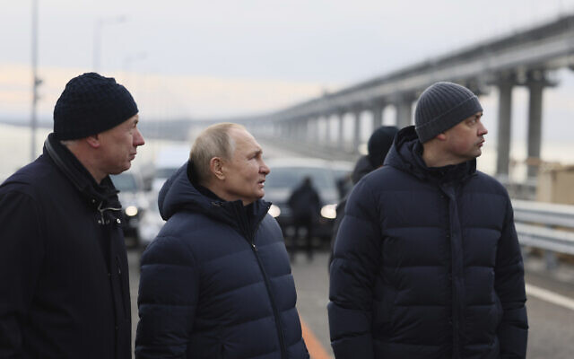 Russian President Vladimir Putin, center, and Deputy Prime Minister Marat Khusnullin, left, visit the Crimean Bridge connecting Russian mainland and Crimean peninsula over the Kerch Strait, which was damaged by a truck bomb attack in October, after restoration works, not far from Kerch, Crimea, Dec. 5, 2022. (Mikhail Metzel, Sputnik, Kremlin Pool Photo via AP) Russian President Vladimir Putin, center, and Deputy Prime Minister Marat Khusnullin, left, visit the Crimean Bridge connecting Russian mainland and Crimean peninsula over the Kerch Strait, which was damaged by a truck bomb attack in October, after restoration works, not far from Kerch, Crimea, Dec. 5, 2022. (Mikhail Metzel, Sputnik, Kremlin Pool Photo via AP)
