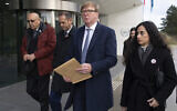 Rodney Dixon, lawyer for Al Jazeera, center with letter, and Lina Abu Akleh, niece of fatally shot Al Jazeera journalist Shireen Abu Akleh, right, walk to to the International Criminal Court in The Hague, Netherlands, to present a letter requesting a formal investigation into the killing, December 6, 2022. (Peter Dejong/AP)