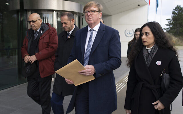 Rodney Dixon, lawyer for Al Jazeera, center with letter, and Lina Abu Akleh, niece of fatally shot Al Jazeera journalist Shireen Abu Akleh, right, walk to to the International Criminal Court in The Hague, Netherlands, to present a letter requesting a formal investigation into the killing, December 6, 2022. (Peter Dejong/AP) Rodney Dixon, lawyer for Al Jazeera, center with letter, and Lina Abu Akleh, niece of fatally shot Al Jazeera journalist Shireen Abu Akleh, right, walk to to the International Criminal Court in The Hague, Netherlands, to present a letter requesting a formal investigation into the killing, December 6, 2022. (Peter Dejong/AP)