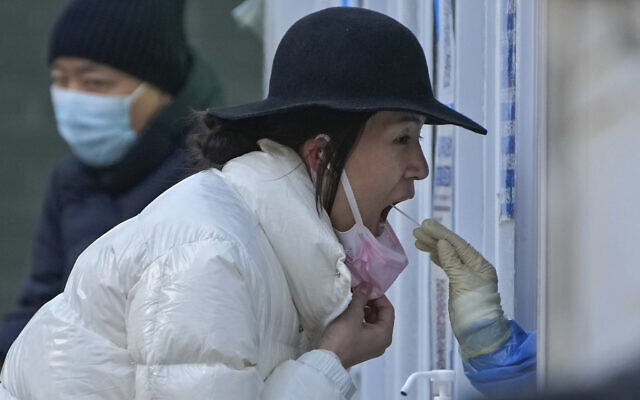 A woman has her routine COVID-19 throat swab at a coronavirus testing site in Beijing, December. 4, 2022. (Andy Wong/AP) A woman has her routine COVID-19 throat swab at a coronavirus testing site in Beijing, December. 4, 2022. (Andy Wong/AP)