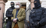 File - Masked police officers lead Heinrich XIII Prince Reuss, center, to a police vehicle during a raid against so-called 'Reich citizens' in Frankfurt, Germany, December 7, 2022. (Boris Roessler/DPA via AP)