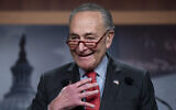 US Senate Majority Leader Chuck Schumer speaks with reporters after Democratic Senator Raphael Warnock defeated Republican challenger Herschel Walker in a runoff election in Georgia, at the Capitol in Washington, December 7, 2022. (AP Photo/J. Scott Applewhite)