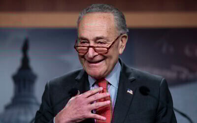US Senate Majority Leader Chuck Schumer speaks with reporters after Democratic Senator Raphael Warnock defeated Republican challenger Herschel Walker in a runoff election in Georgia, at the Capitol in Washington, December 7, 2022. (AP Photo/J. Scott Applewhite)