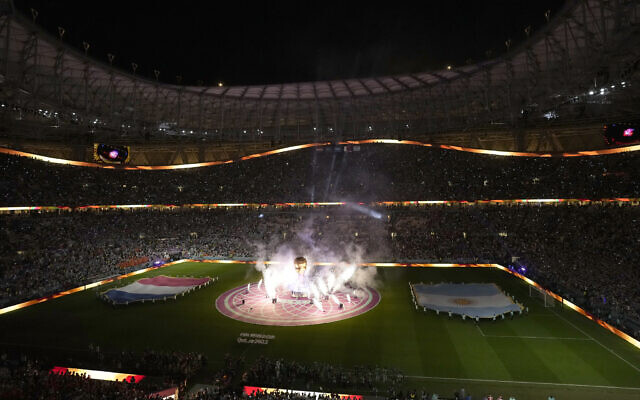 Fireworks go off around a mock of a World Cup trophy prior to the start of the World Cup quarterfinal soccer match between the Netherlands and Argentina, at the Lusail Stadium in Lusail, Qatar, Friday, Dec. 9, 2022. (AP Photo/Thanassis Stavrakis)