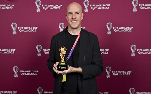 Grant Wahl smiles as he holds a World Cup replica trophy during an award ceremony in Doha, Qatar, on November 29, 2022. (Brendan Moran, FIFA via AP) Grant Wahl smiles as he holds a World Cup replica trophy during an award ceremony in Doha, Qatar, on November 29, 2022. (Brendan Moran, FIFA via AP)
