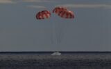 The Orion spacecraft for the Artemis I mission splashes down in the Pacific Ocean after a 25.5 day mission to the moon, December 11, 2022. (NASA via AP)