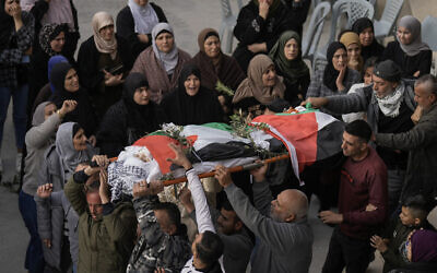 Palestinians carry the body of Jana Zakarna, 16, during her funeral in the West Bank city of Jenin, December 12, 2022. (AP Photo/Majdi Mohammed)